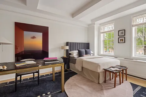 a bedroom with a bed and a desk