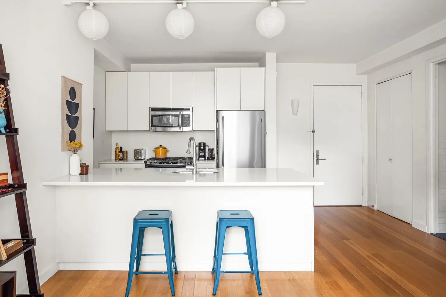 a kitchen with stainless steel appliances a refrigerator and a stove