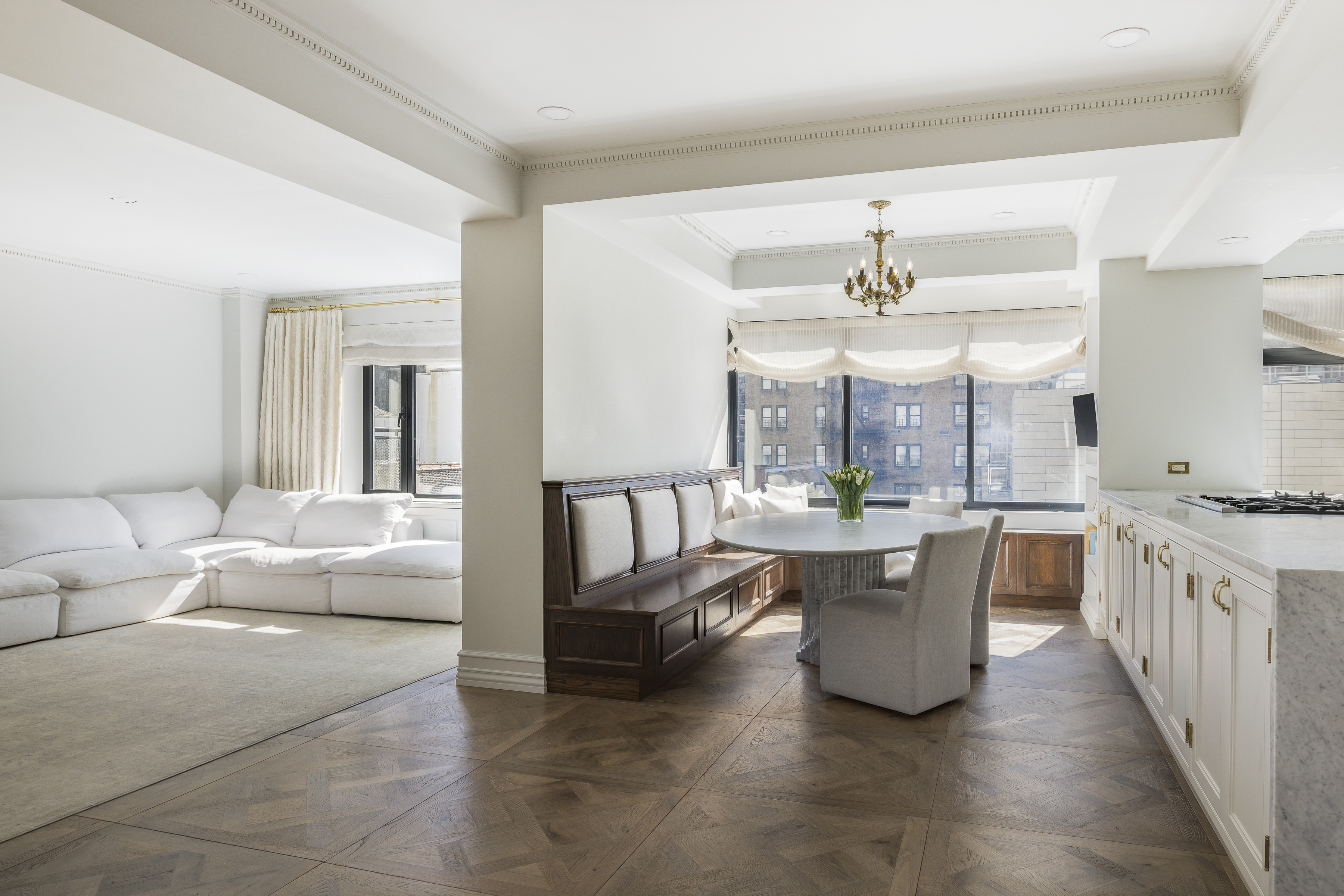 47 East 87th Street, Unit 7A Manhattan, NY 10128 - Photo 6 of 22 a living room with furniture a large window and a dining table