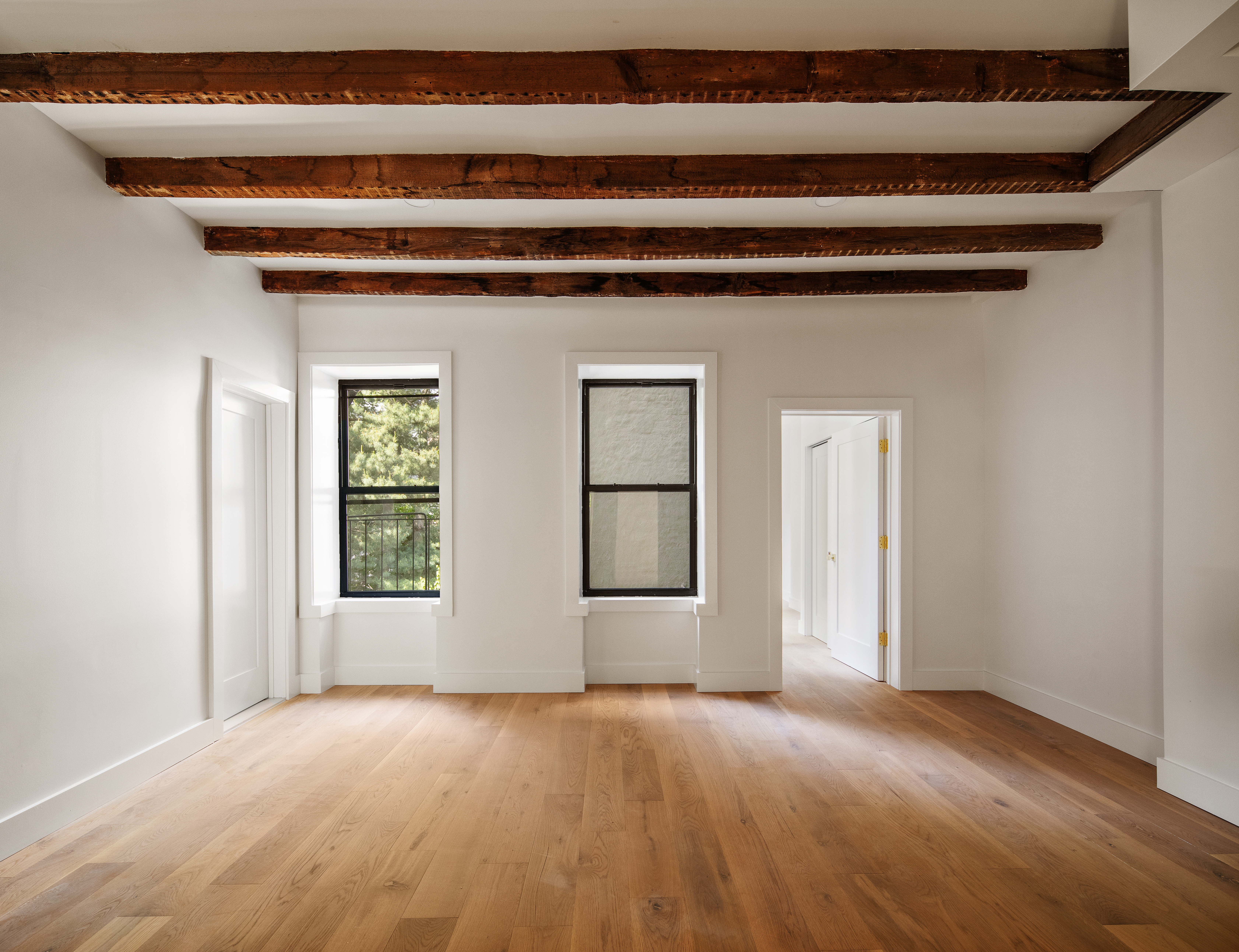 324 Clermont Avenue, Unit 4 Brooklyn, NY 11205 - Photo 2 of 9 a view of an empty room with wooden floor and a window