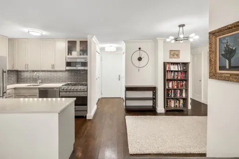 a kitchen with stainless steel appliances granite countertop a stove and a refrigerator