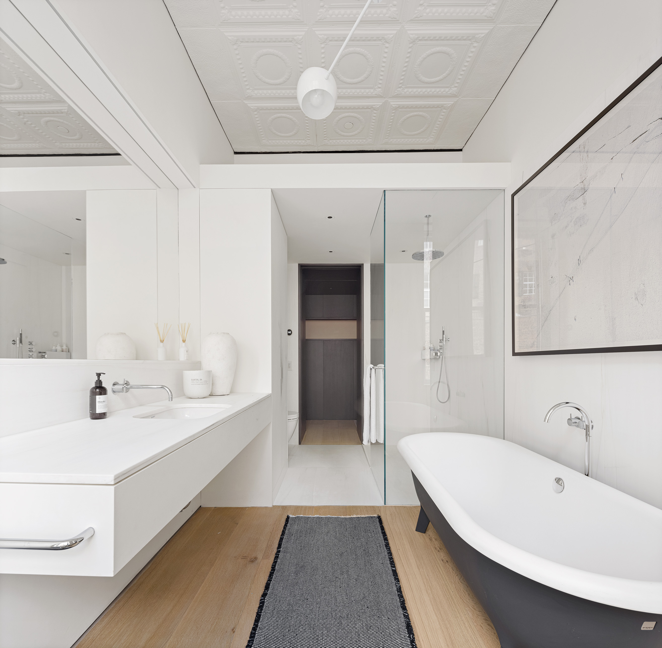 100 Grand Street, Unit 4 Manhattan, NY 10013 - Photo 7 of 13 a spacious bathroom with a bathtub and a sink