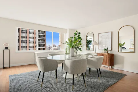 a dining room with furniture and window