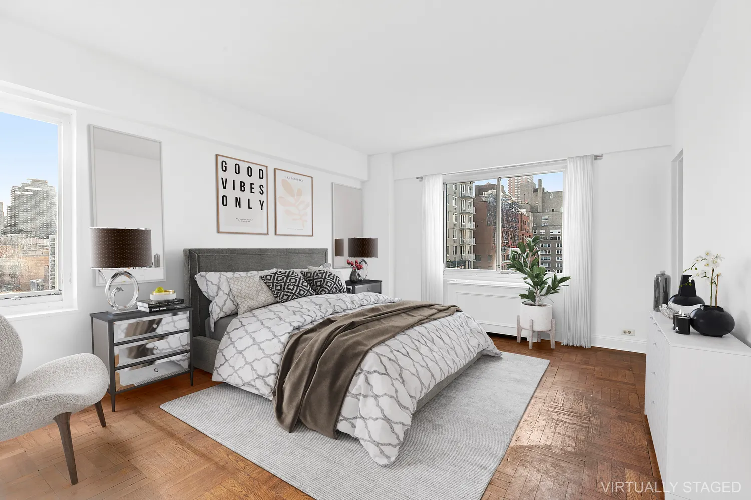 a spacious bedroom with a bed a couch and large window