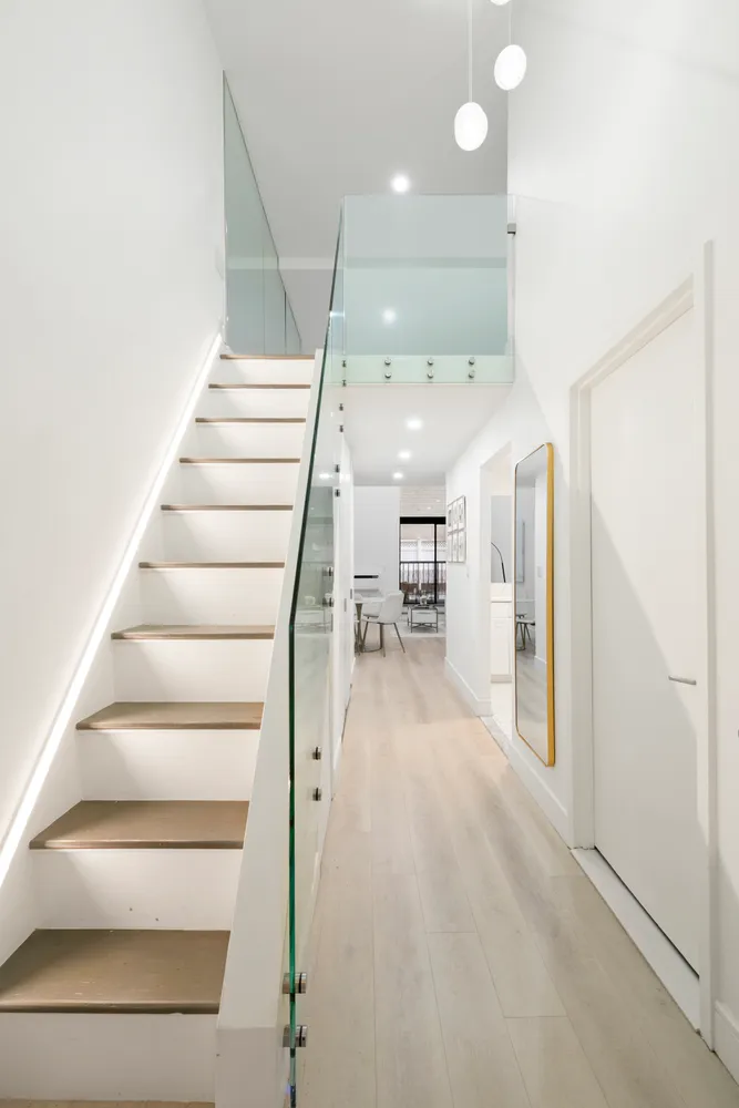 a view of entryway and hall with wooden floor