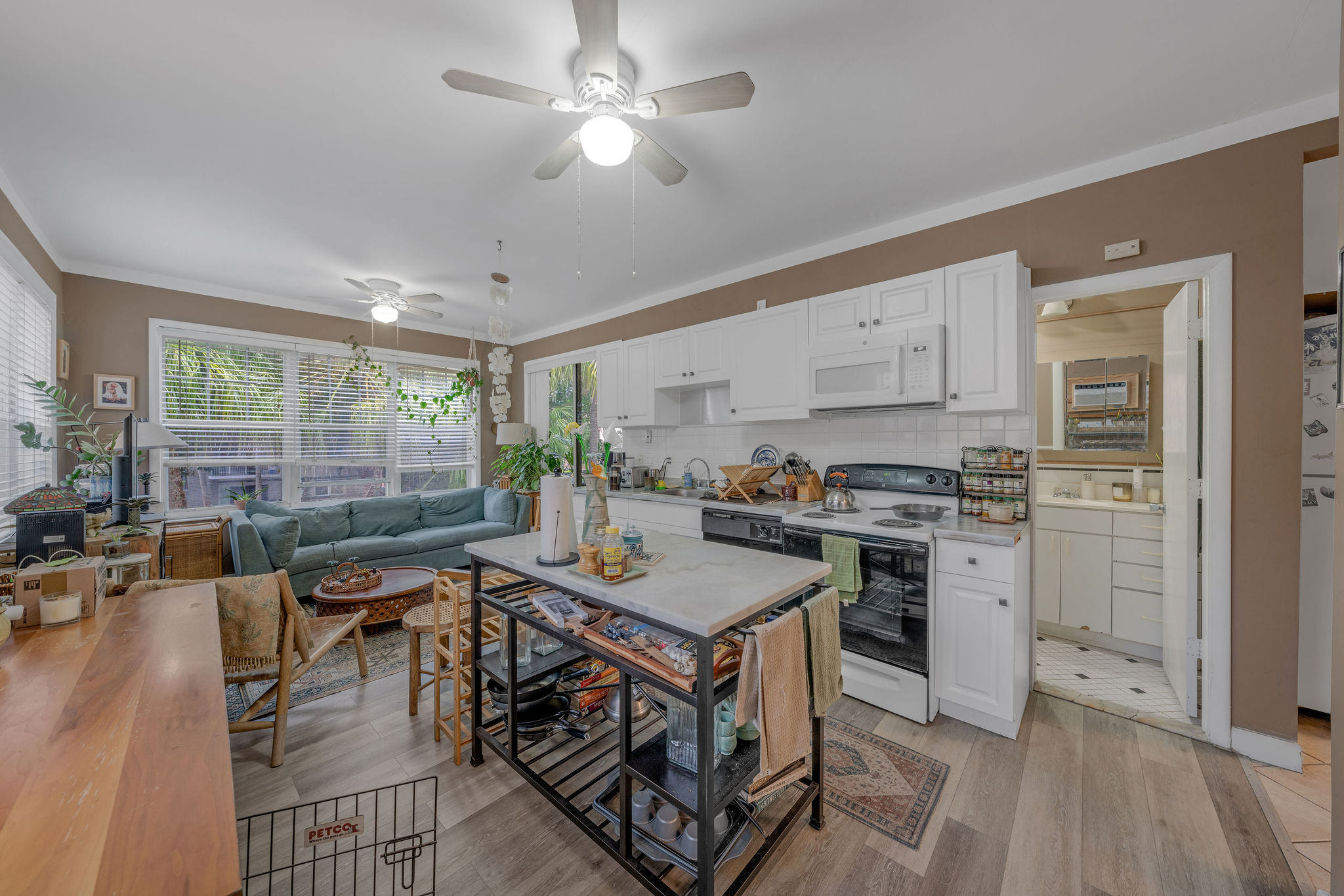 735-745 Meridian Avenue Miami Beach, FL 33139 - Photo 13 of 62 a view of a kitchen with kitchen island stainless steel appliances a stove a table and chairs in it