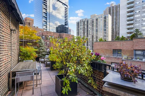 a view of a patio with a table and chairs and potted plants