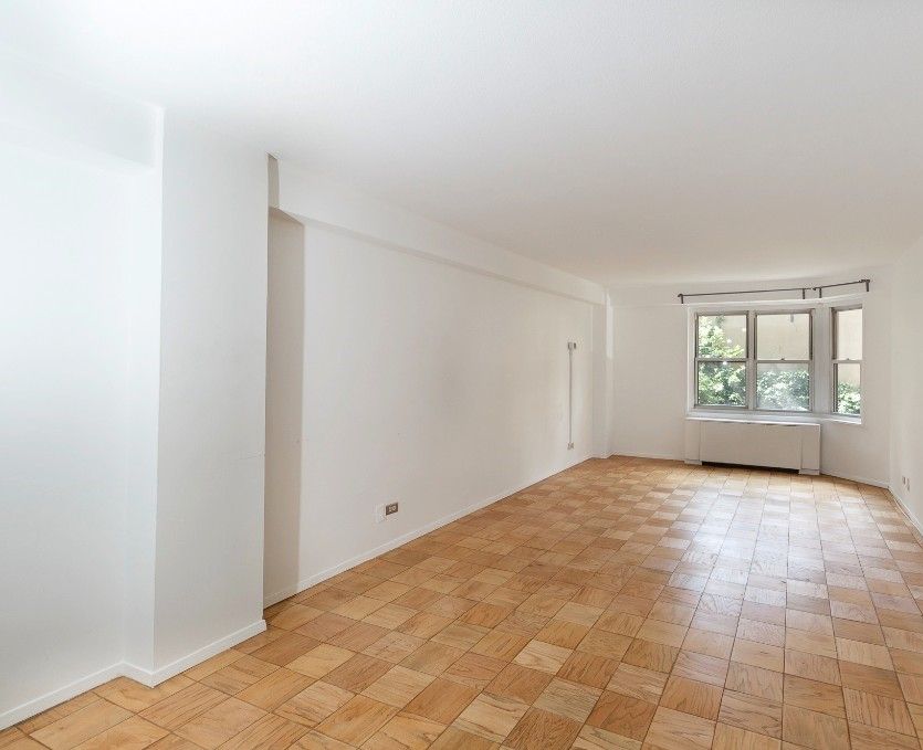 220 East 60th Street, Unit 2J Manhattan, NY 10022 - Photo 2 of 8 a view of an empty room with a window