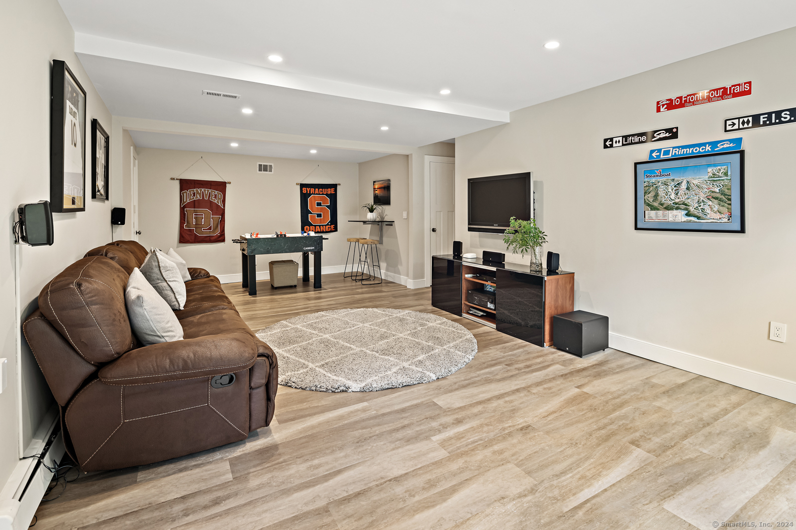 13 Bittersweet Road Weston, CT 06883 - Photo 23 of 35 a living room with furniture and a flat screen tv