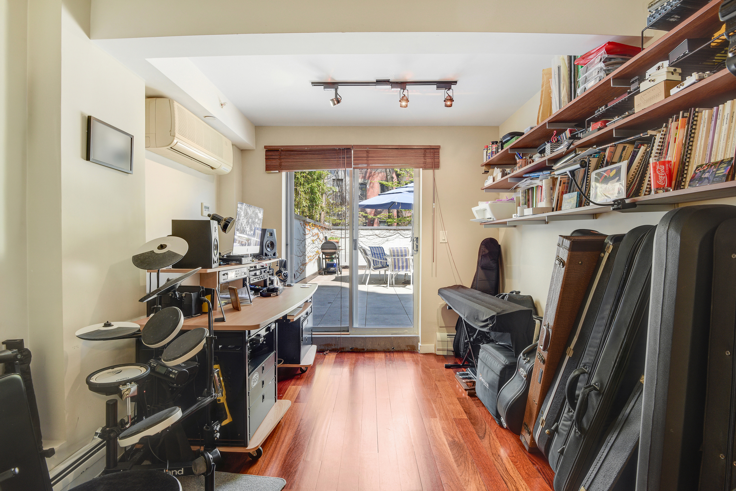335 Warren Street, Unit 102 Brooklyn, NY 11201 - Photo 7 of 20 a view of a workspace with furniture and a large window