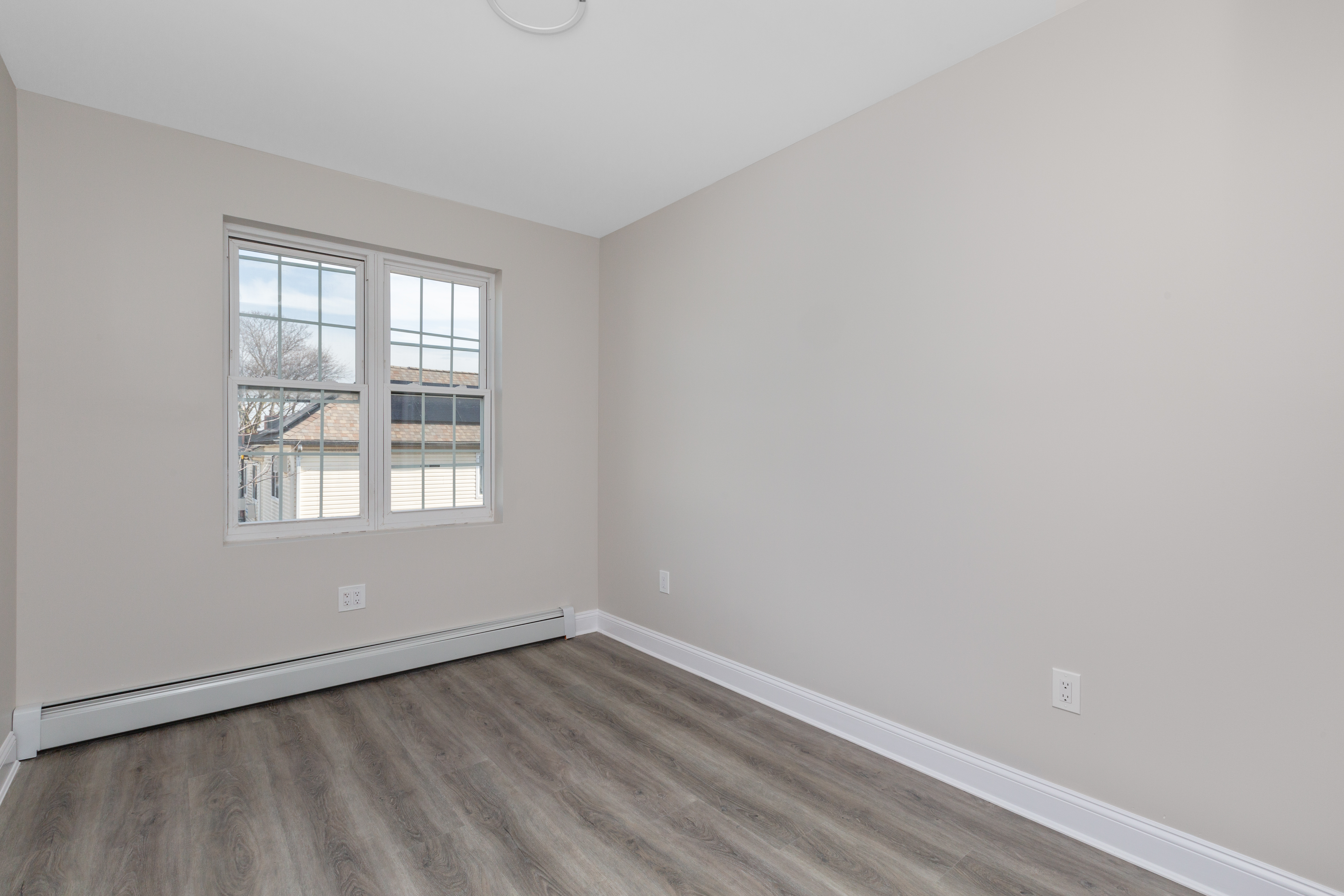 143-10 Shore Avenue Queens, NY 11435 - Photo 10 of 30 an empty room with a window