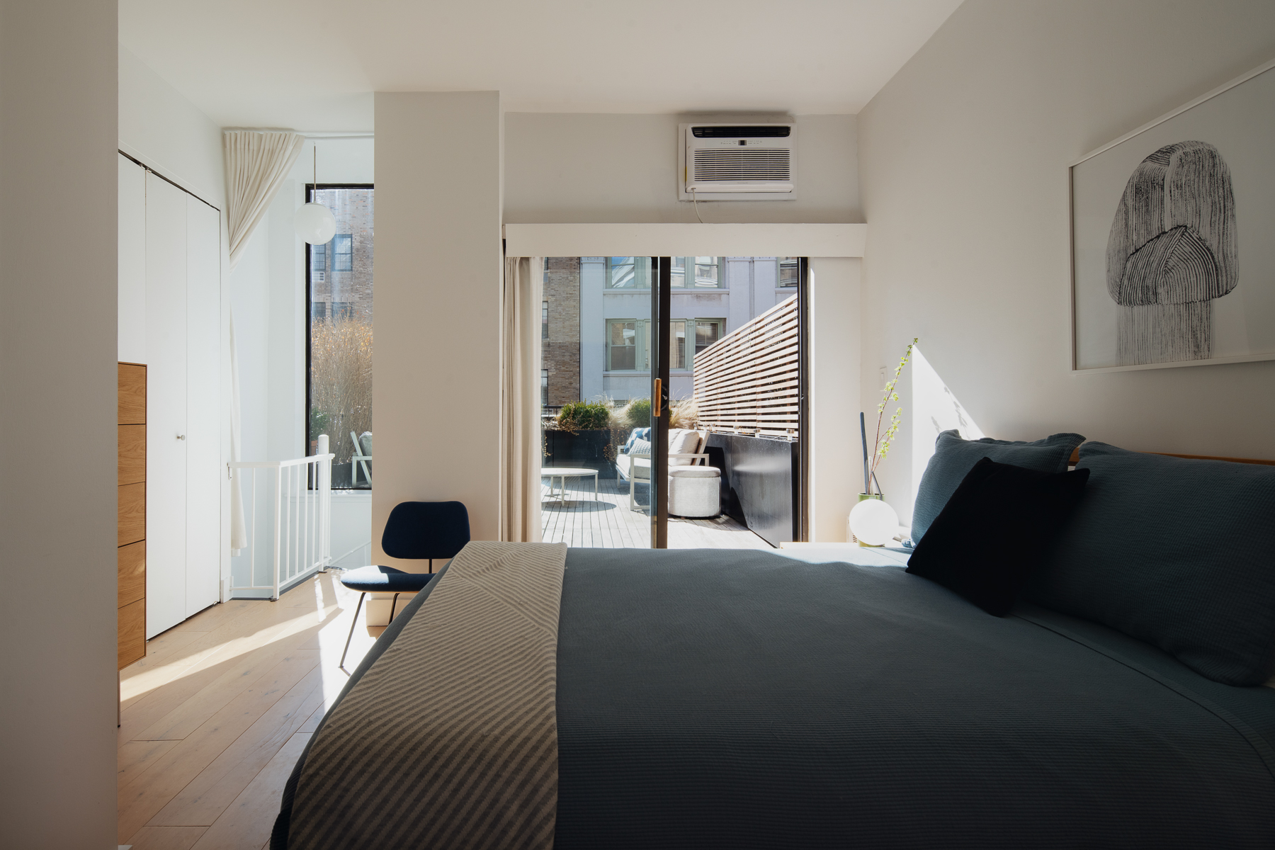 35 East 10th Street, Unit 4J Manhattan, NY 10003 - Photo 8 of 19 a bed room with a bed and a couch