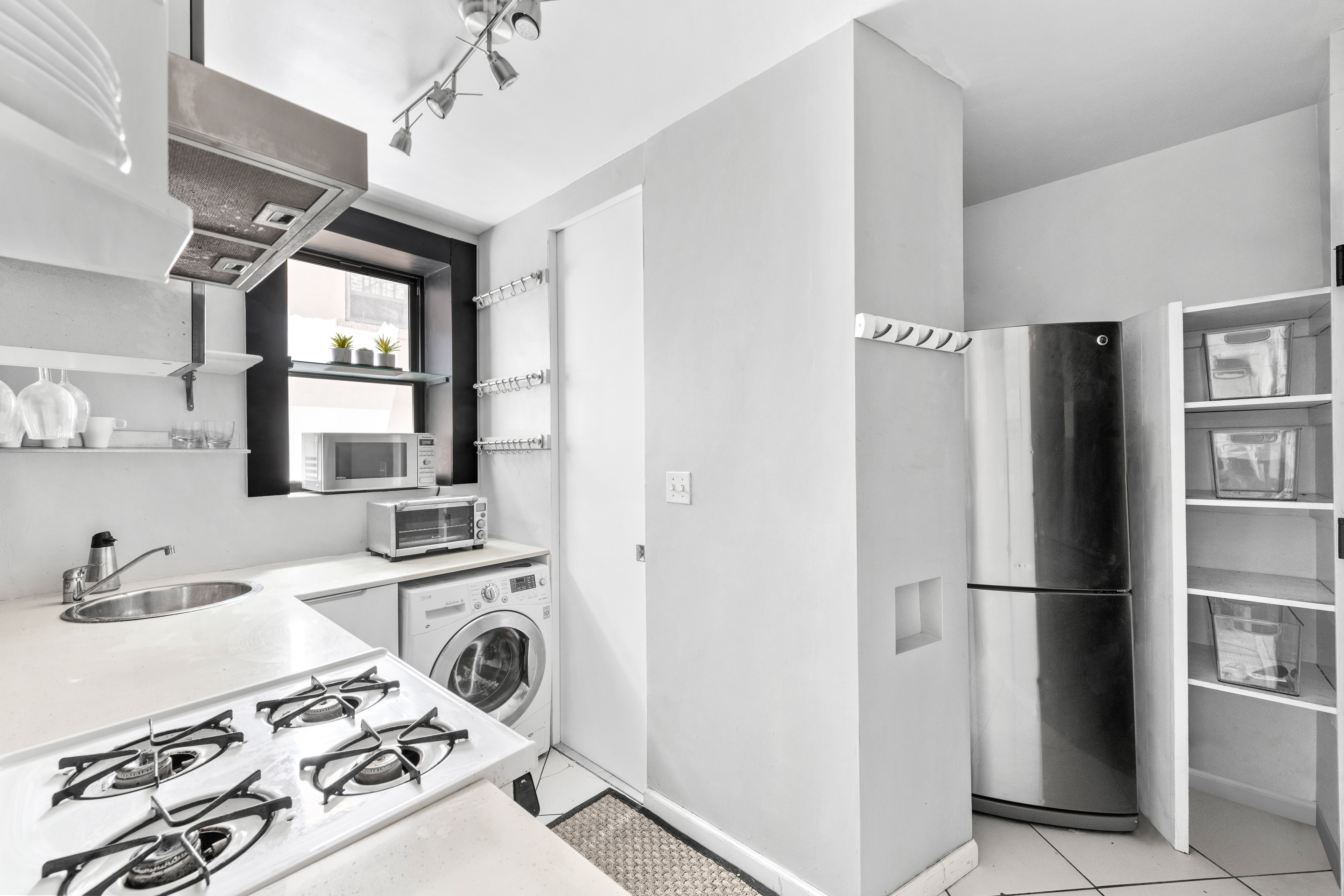 321 East 12th Street, Unit 24 Manhattan, NY 10003 - Photo 4 of 8 a kitchen with stainless steel appliances granite countertop a refrigerator and a sink