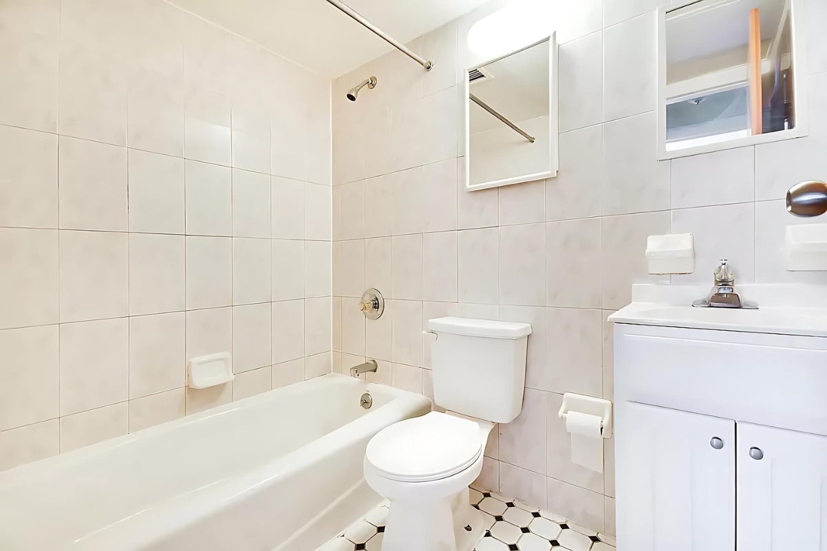 247 East 81st Street, Unit 3E Manhattan, NY 10028 - Photo 5 of 6 a bathroom with a sink a toilet and shower