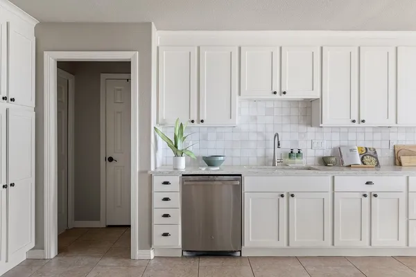 a kitchen with stainless steel appliances granite countertop a sink and a stove
