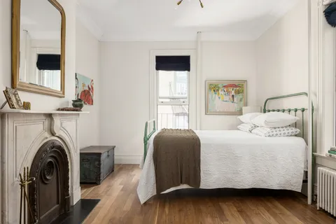 a bedroom with a bed and a large window