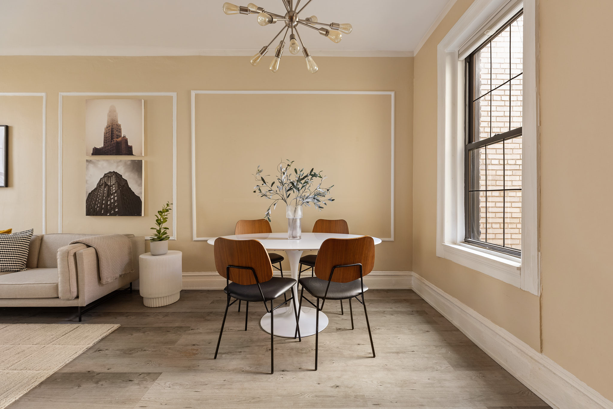 340 West 19th Street, Unit 20 Manhattan, NY 10011 - Photo 2 of 8 a dining room with furniture a rug and a chandelier