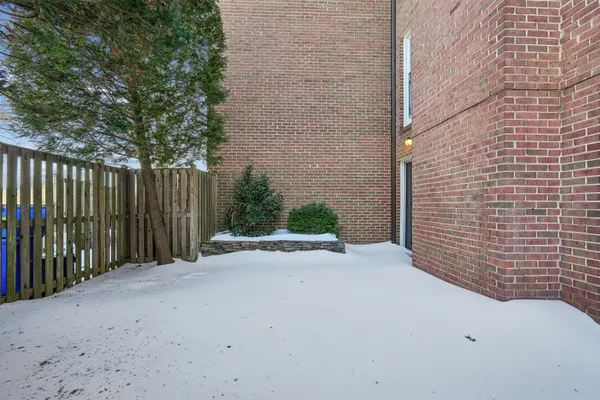 a sidewalk with a wooden fence