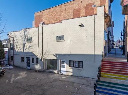 a front view of a building with a garden