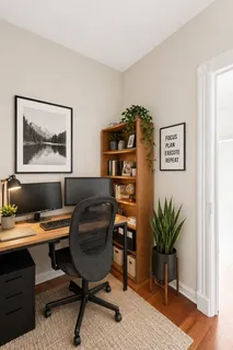 a view of a workspace with furniture and a potted plant