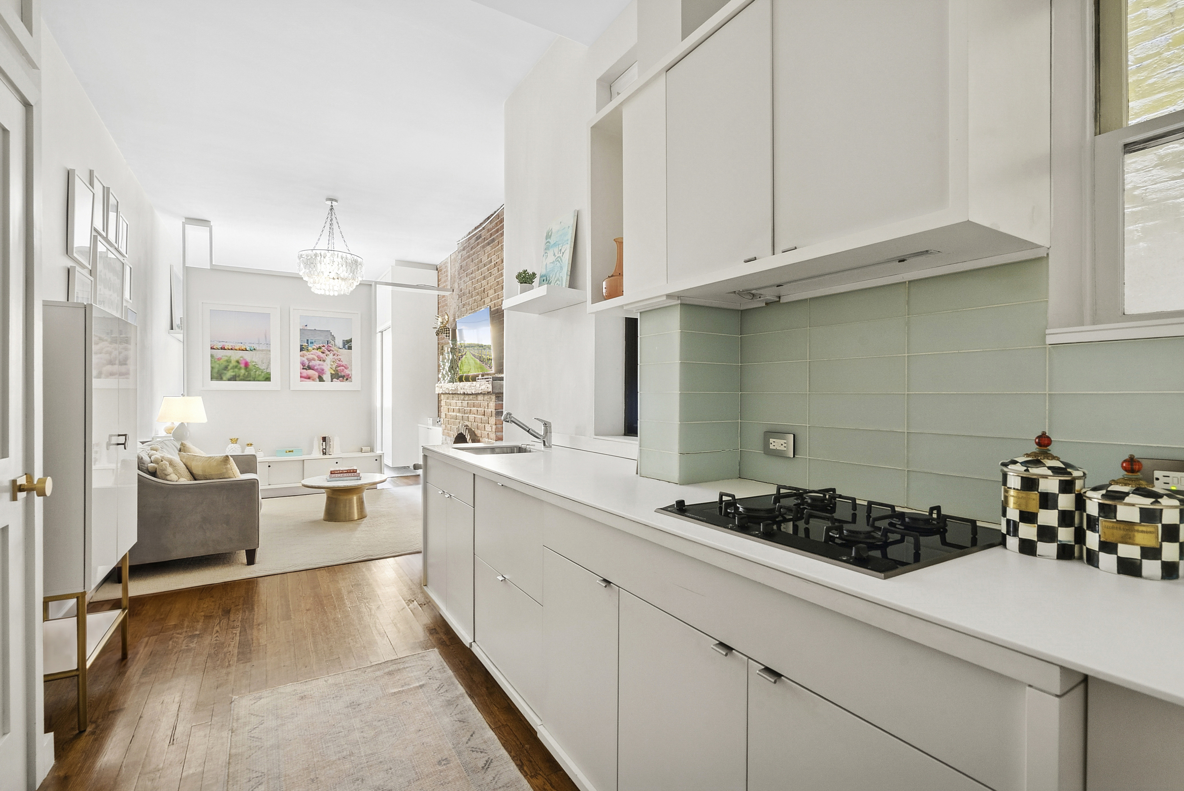 252 West 20th Street, Unit 2B Manhattan, NY 10011 - Photo 2 of 6 a kitchen that has a lot of cabinets in it and wooden floors