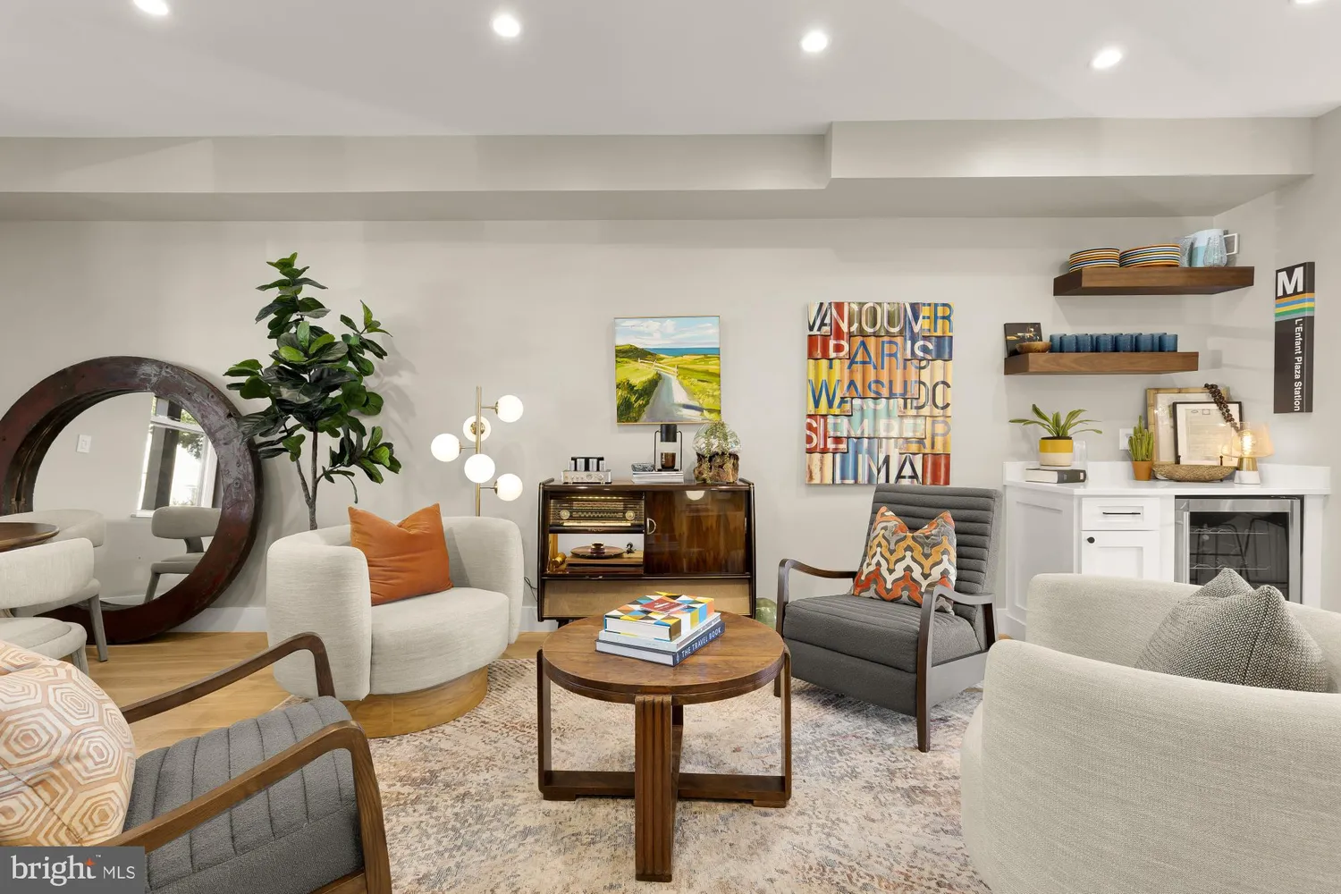 a living room with furniture a rug and a potted plant
