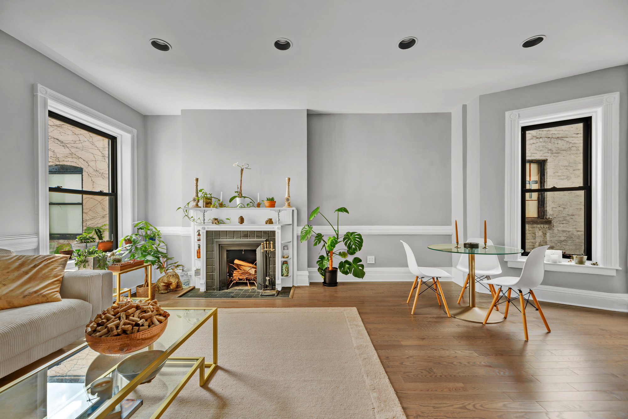 72 East 93rd Street, Unit 5AB Manhattan, NY 10128 - Photo 4 of 17 a living room with furniture a fireplace and a large window