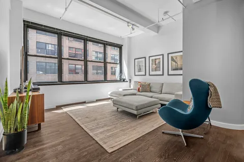 a living room with furniture rug and window