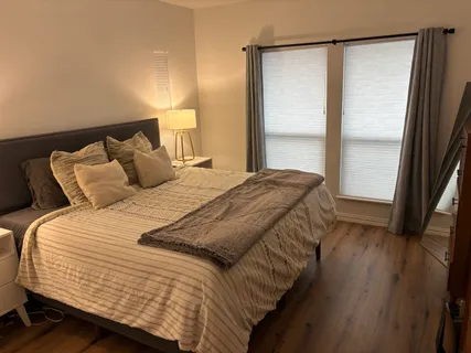 a bedroom with a bed and a window