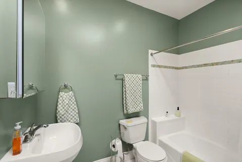 a bathroom with a sink toilet and mirror
