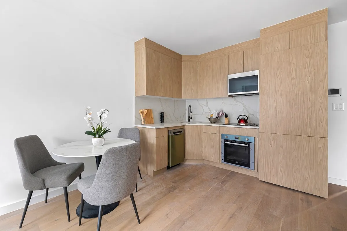 1220 Putnam Avenue, Unit 2B Brooklyn, NY 11221 - Photo 2 of 5 a view of kitchen with cabinets and wooden floor