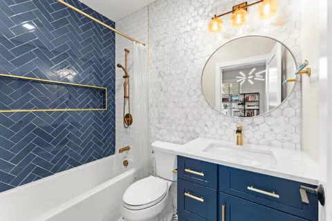 a bathroom with a sink a toilet and bathtub