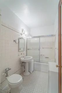 a bathroom with a toilet a sink and mirror