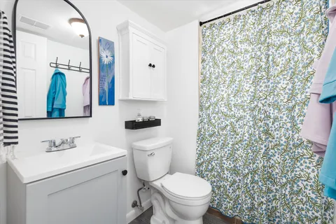 a bathroom with a sink toilet and shower