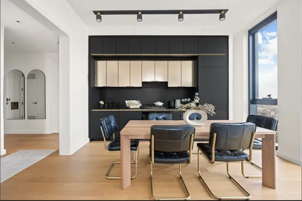 a kitchen with a table chairs and a refrigerator