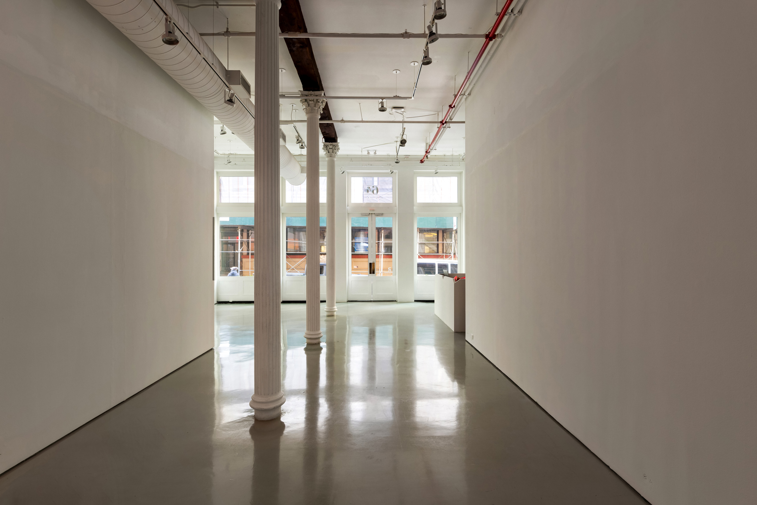 64 White Street, Unit RETAIL Manhattan, NY 10013 - Photo 9 of 31 a view of an empty room with wooden floor and a window