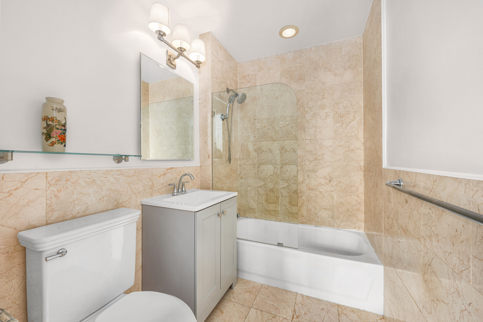 163 St Nicholas Avenue, Unit 1I Manhattan, NY 10026 - Photo 9 of 12 a bathroom with a sink toilet and shower