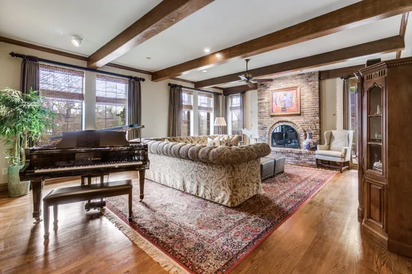 a kitchen with white cabinets and chairs