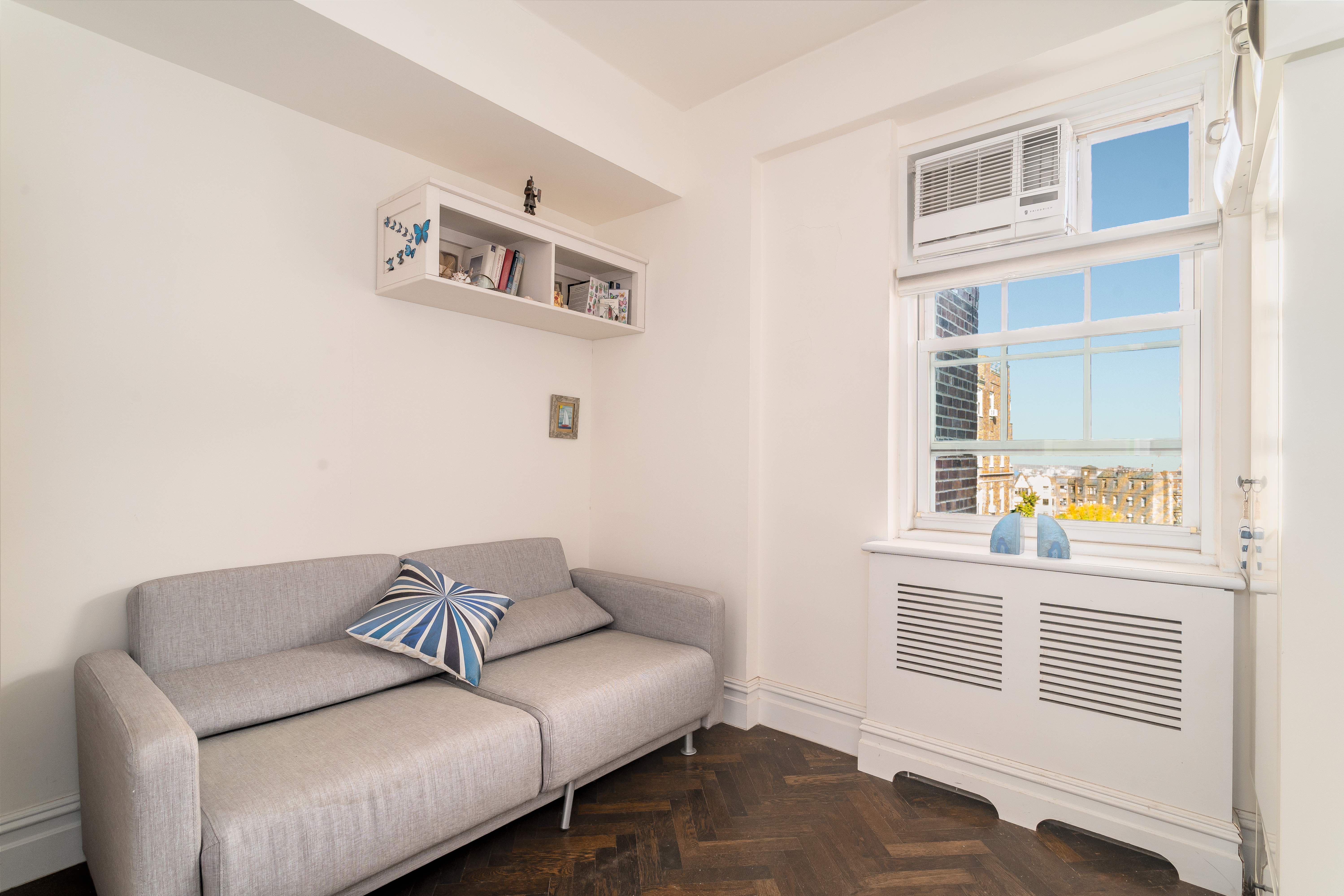 140 Cabrini Boulevard, Unit PH138 Manhattan, NY 10033 - Photo 11 of 30 a living room with furniture and a window