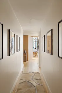 a view of an entryway with wooden floor and a livingroom