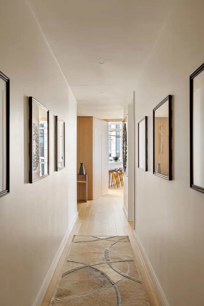 a view of an entryway with wooden floor and a livingroom