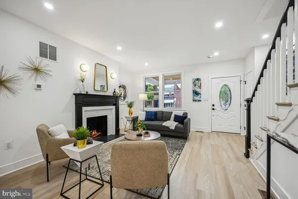 a living room with furniture and a fireplace