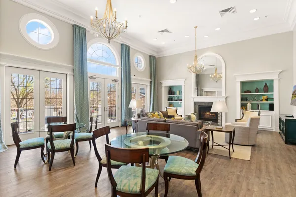 a living room with fireplace furniture and a chandelier
