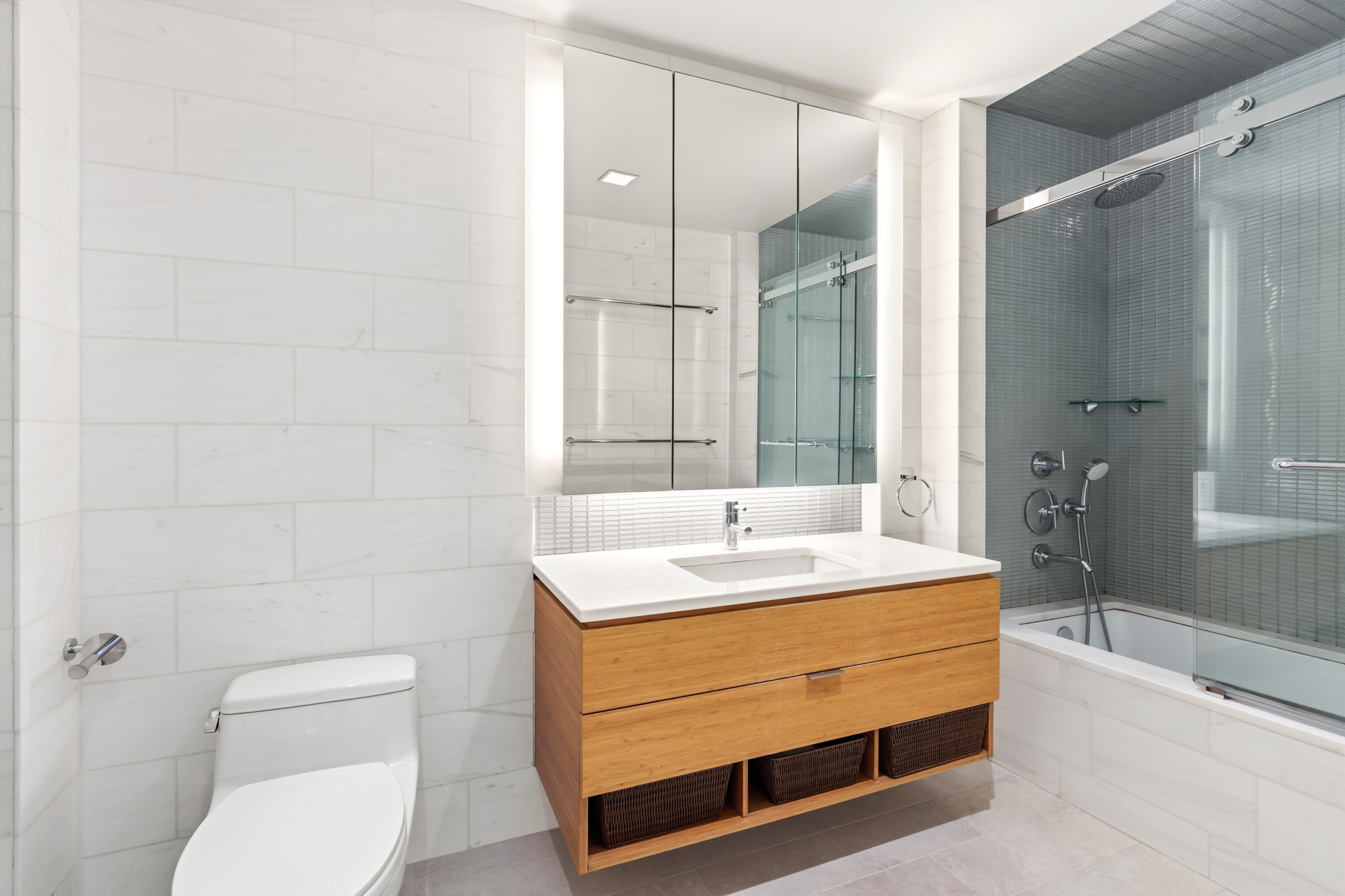 303 East 33rd Street, Unit 5H Manhattan, NY 10016 - Photo 7 of 18 a bathroom with a sink a toilet and shower
