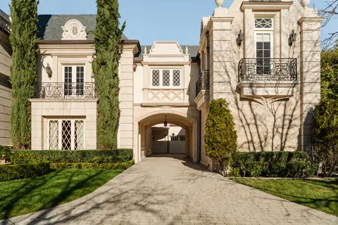 a front view of a residential apartment building with a yard