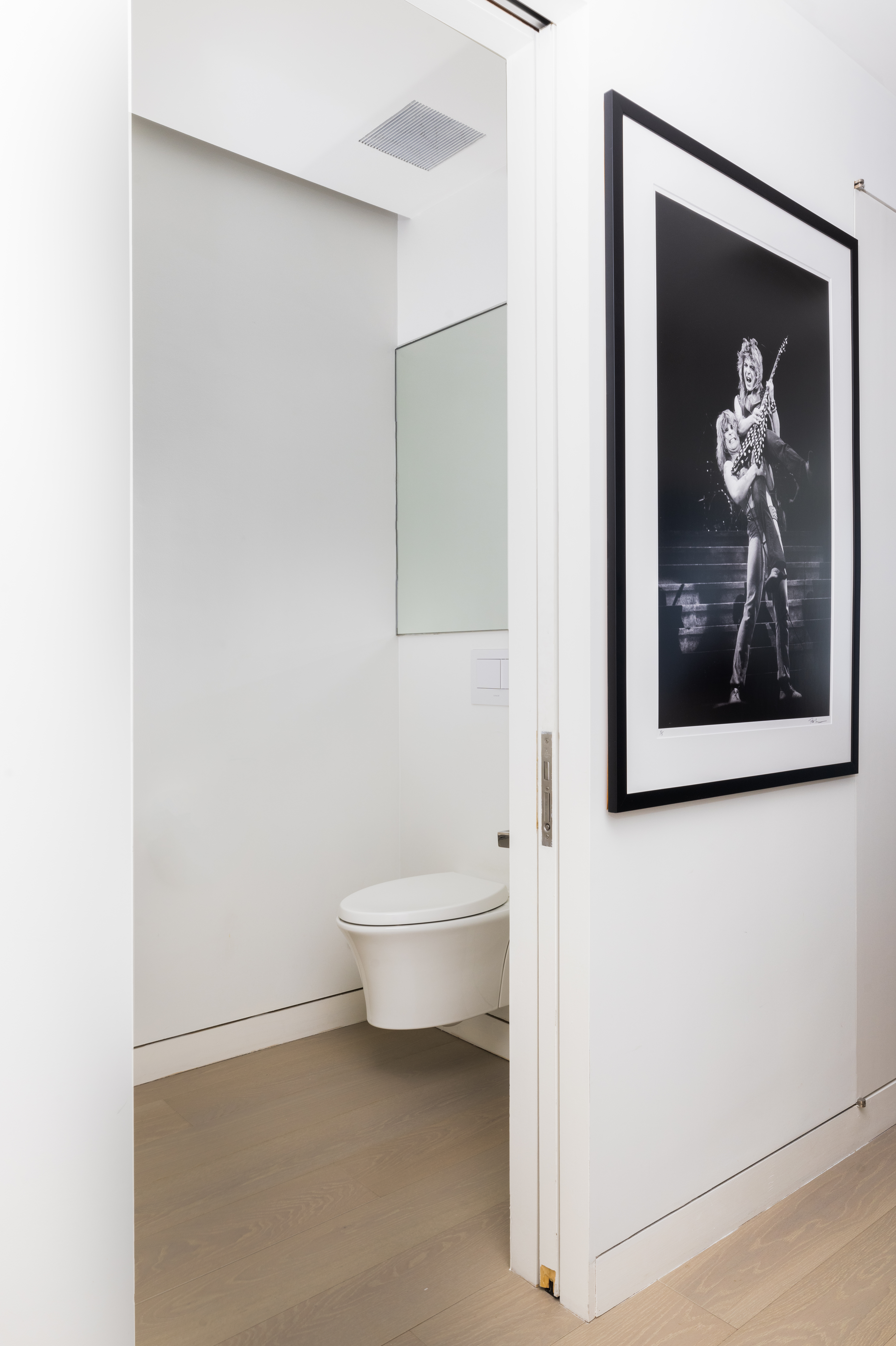 255 Hudson Street, Unit 9C Manhattan, NY 10013 - Photo 8 of 19 a bathroom with a toilet and a painting on the wall