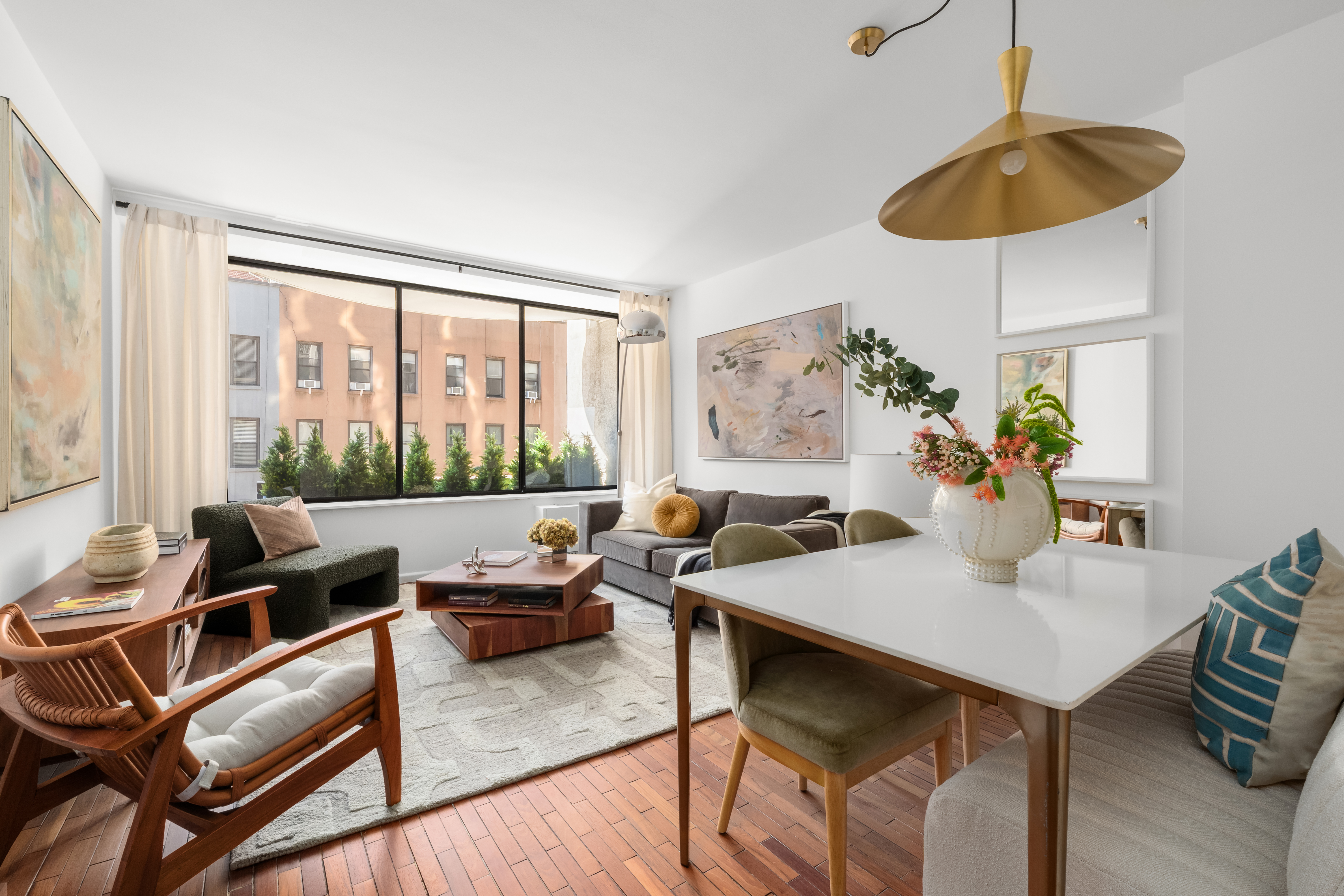 150 East 85th Street, Unit 3F Manhattan, NY 10028 - Photo 1 of 15 a living room with furniture and a large window