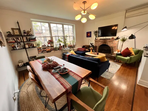a living room with furniture a fireplace and a flat screen tv