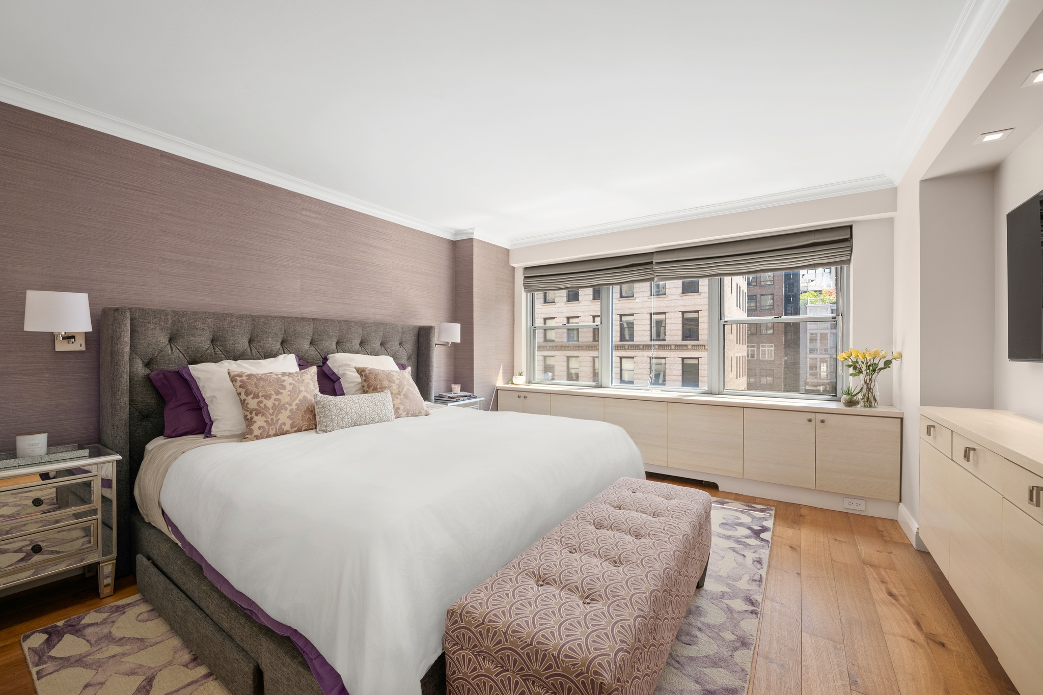 10 West 15th Street, Unit 1027/1028 Manhattan, NY 10011 - Photo 5 of 15 a large bed sitting in a bedroom next to a window with lamp