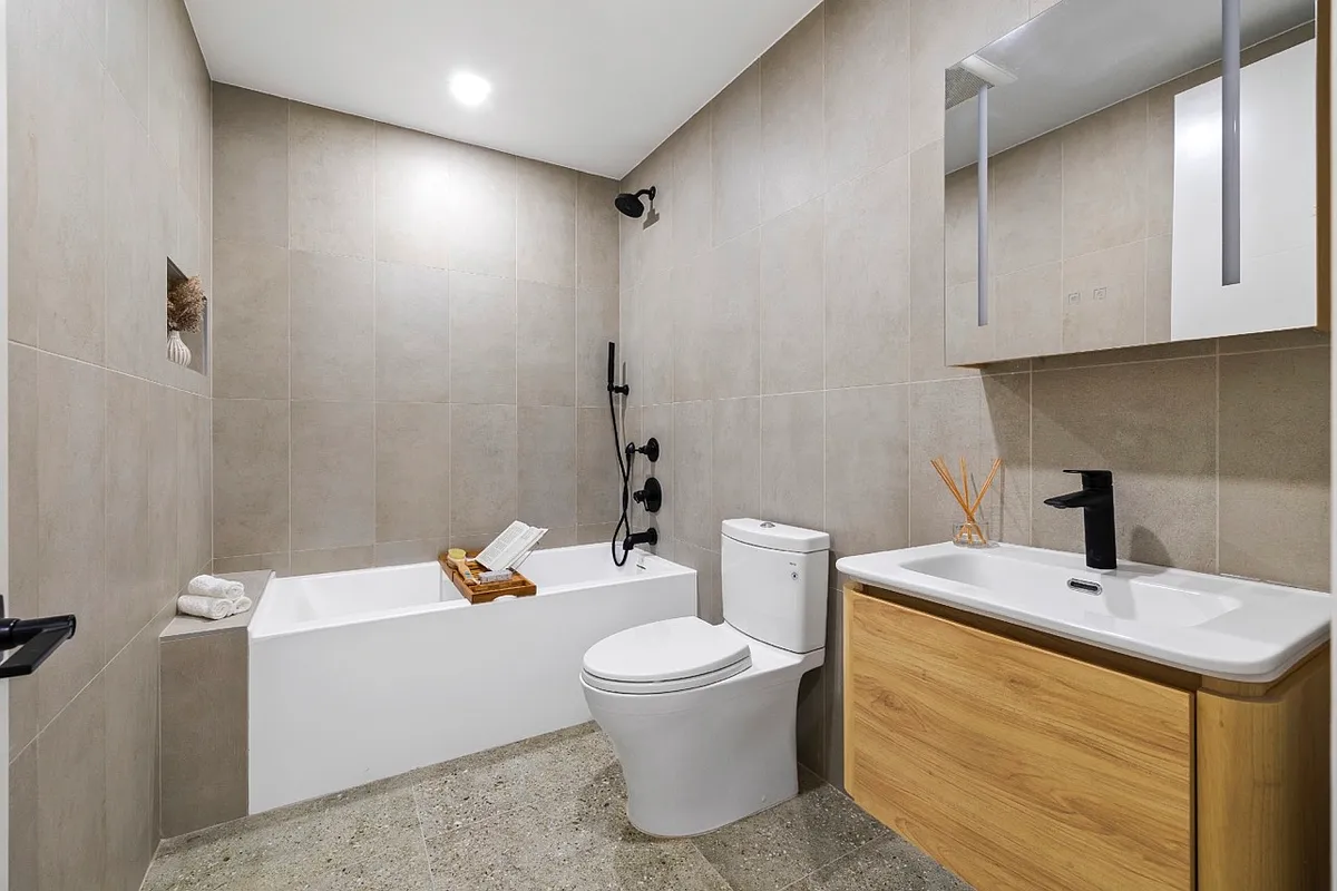 1220 Putnam Avenue, Unit 2B Brooklyn, NY 11221 - Photo 4 of 5 a bathroom with a sink a toilet and shower